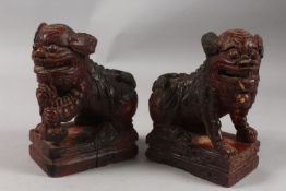 A PAIR OF CHINESE CARVED WOOD FOO DOGS, 21.5cm high.