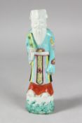 A CHINESE PORCELAIN FIGURE OF AN OFFICIAL, 23.5cm high.