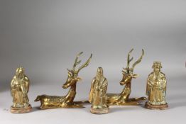 A PAIR OF BRASS DEER, together with three brass immortals with wooden stands, (5).