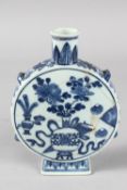 AN 18TH-19TH CENTURY CHINESE BLUE AND WHITE PORCELAIN MOON FLASK, painted with a central vase of