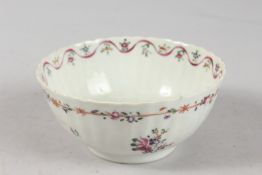 AN 18TH-19TH CENTURY CHINESE FAMILLE ROSE PORCELAIN BOWL, of ribbed form with painted floral