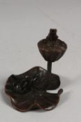 A BRONZE OKIMONO OF A FROG ON A LILY PAD WITH LOTUS.
