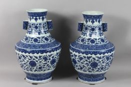 A VERY LARGE PAIR OF CHINESE BLUE AND WHITE PORCELAIN TWIN HANDLE FLORAL VASES, each with