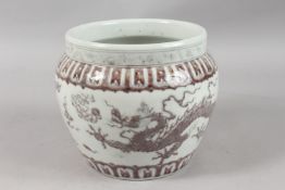 A CHINESE UNDERGLAZE RED AND WHITE PORCELAIN DRAGON JARDINIERE, 19cm high.