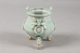 A CHINESE YING CHING GLAZE POTTERY TRIPOD CENSER, with moulded and carved relief decoration,