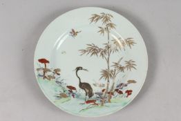A CHINESE QIANLONG PORCELAIN PLATE, painted with a crane and bamboo with mushroom heads,