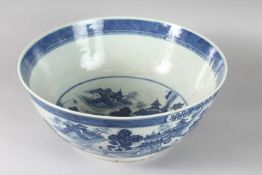 A VERY LARGE CHINESE BLUE AND WHITE PORCELAIN PUNCH BOWL, decorated with buildings in a landscape