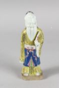 A 19TH CENTURY CHINESE POLYCHROME GLAZED POTTERY FIGURE OF A SAGE, 19cm high.