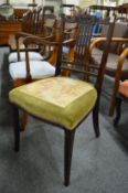 A mahogany occasional chair and pair of dining chairs with arms.