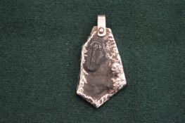 A silver mounted trilobite pendant.
