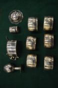 A group of Eastern white metal napkin rings and similar condiments.