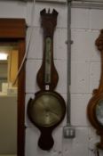 A Georgian wheel barometer, the silvered dial signed C Tarelli, Northampton.