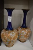 A pair of Royal Doulton bottle vases.