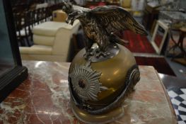 A large Prussian brass and leather helmet with eagle mount.