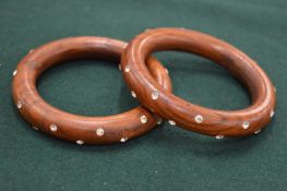 A pair of wooden bangles with diamante studded decoration.