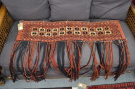 A Persian Tekke wall hanging, 104cm x 27cm.