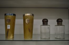 A pair of large silver mounted horn beakers together with a pair of glass scent bottles with horn