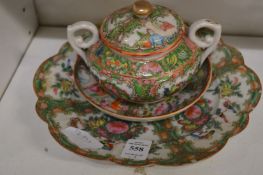 A famille rose bowl and cover with similar stand and plate.