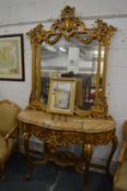 A decorative marble and gilded serpentine fronted console table with matching mirror.