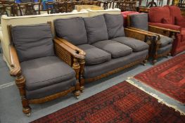 A oak framed bergere three piece suite.