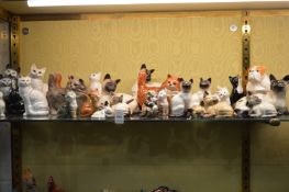 A collection of Beswick and other model cats.