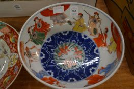 Japanese circular bowl painted with figures together with two other dishes.