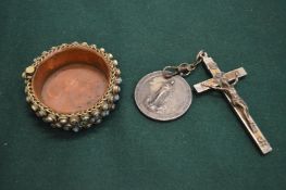 A crucifix with medallion and a decorative trinket bowl studded with turquoise.