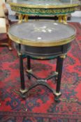A Victorian ebonised and ormolu mounted circular occasional table with an inlaid Ashby slate top.