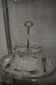 A Continental silver oil and vinegar stand with cut glass jugs together with an hors d'oeuvre set.