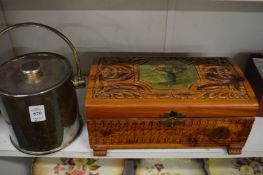 A plated ice bucket and a carved wood casket.
