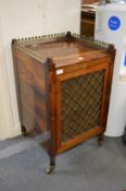 A good Regency brass inlaid rosewood pedestal cupboard with brass gallery and lattice work door.