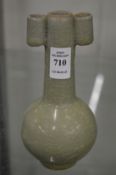 A small crackle glazed bottle vase with tube style handles.