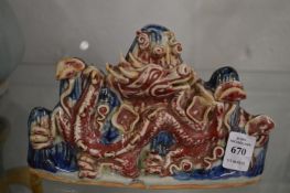 A Chinese sang de boeuf and blue glazed mountain group with dragon.