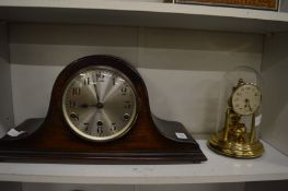 An oak cased mantel clock and an anniversary style clock.