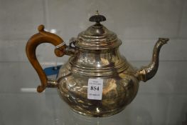 A silver teapot.