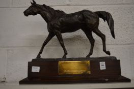 A bronze resin horse trophy.
