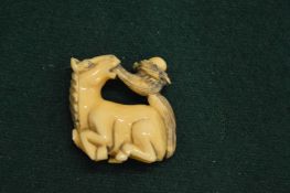 Chinese carved bone netsuke modelled as a horse.