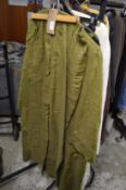 A collection of ladies green linen clothing.