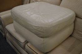 Beige leather footstool.