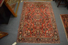 A good Persian rug, red ground with stylised floral decoration, 153cm x 105cm.