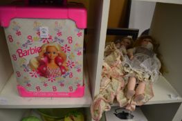 A Barbie trunk and two collectors dolls.