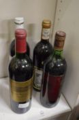 A bottle of Chateau Tourteau Chollet 1988 and three other unrelated bottles.
