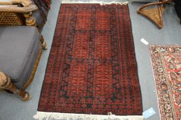 A Persian design rug, red ground with stylised decoration, 151cm x 97cm.