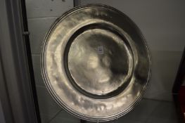 A large modern pewter charger.
