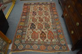 An old Persian Caucasion rug, cream ground with stylised large Boteh design, 200cm x 120cm.