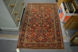 A good Persian rug, rust ground with stylised floral decoration, 148cm x 99cm.