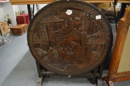 A Chinese carved wood circular fire screen/table.