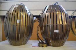 A pair of large stylish metal ceiling lights.