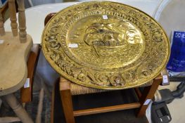 Embossed brass charger and a stool.