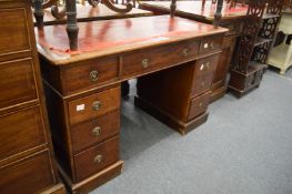 A Victorian mahogany twin pedestal desk with leather inset writing surface and drop-flap extension.